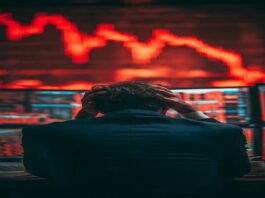 Investor analyzing falling stock market amid hidden investment risks